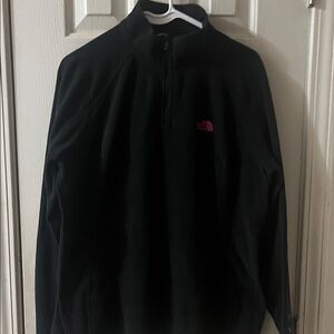 TNF quarter zip in black with a pink breast cancer awareness logo on left sleeve